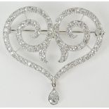 Lady's vintage round cut diamond and platinum heart shape pendant/brooch with hanging briolette