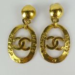 Large Pair of Chanel, Made in France Gold Tone Logo Earrings. Signed. Good condition with box.