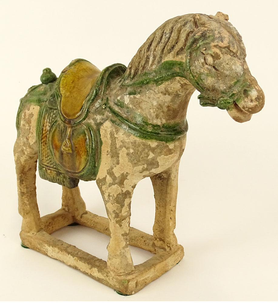 Chinese Ming Dynasty (1368-1644) Partially Glazed Pottery Figure Of A Saddled Horse. The molded