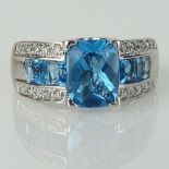 Lady's London Blue Topaz, Diamond and 14 karat White Gold Ring. Topaz with vivid saturation of