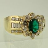 Lady's Oval Cut Emerald, Diamond and 14 Karat Yellow Gold Ring. Emerald with vivid saturation of