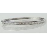 Lady's Baguette Diamond and 14 Karat White Gold Bangle Bracelet. Diamonds F-G Color, VS Clarity.