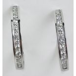 Lady's Round Cut Diamond and 14 Karat White Gold Hoop Earrings. Diamonds F-G Color, VS Clarity.