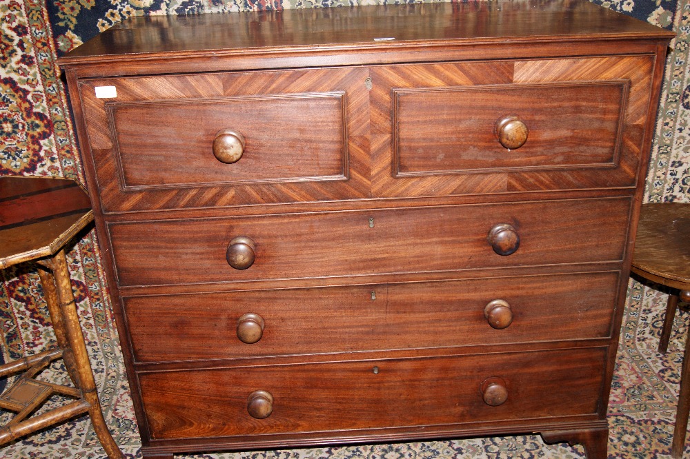 Mahogany secretaire with fitted desk drawer above three other drawers, raised on bracket feet