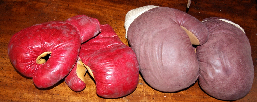 Two pairs of vintage leather child's boxing gloves, together with two pairs of hockey shin-pads and