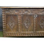 Early 17th Century oak-panelled coffer, heavily carved to the front and having later additions.