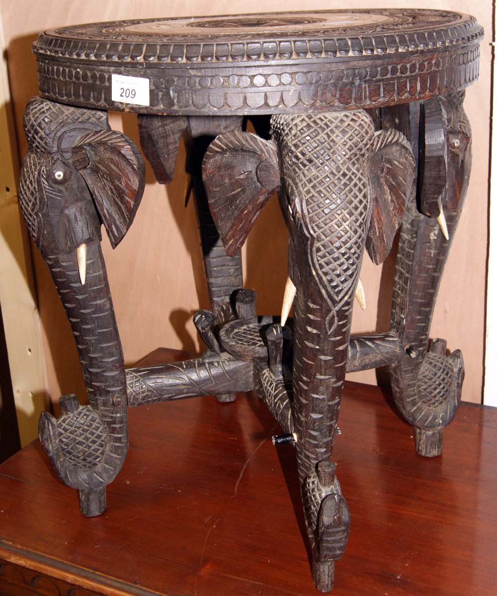 Heavily carved and inlaid oak elephant table