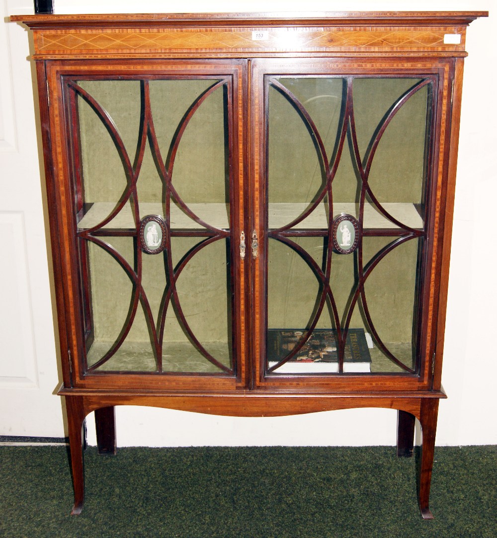 A Sheraton revival mahogany two door display cabinet, inlaid with satinwood, each door having an