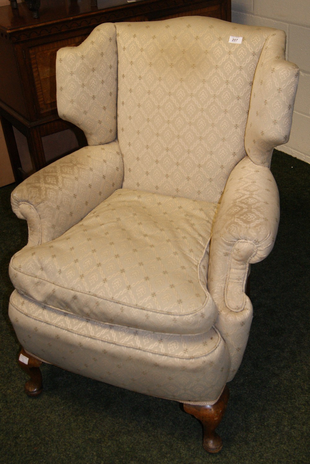 Antique upholstered wing-back chair