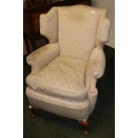 Antique upholstered wing-back chair