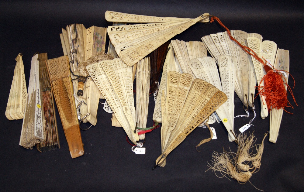 A selection of hand fans, including carved bone and painted silk hand fans, reticulated bone