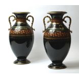 Jackfield, a pair of urn form vases, gilt and coloured decoration against a black ground and glazed.