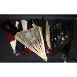 A selection of hand fans, including two Victorian black silk hand fans, one with an applied painted