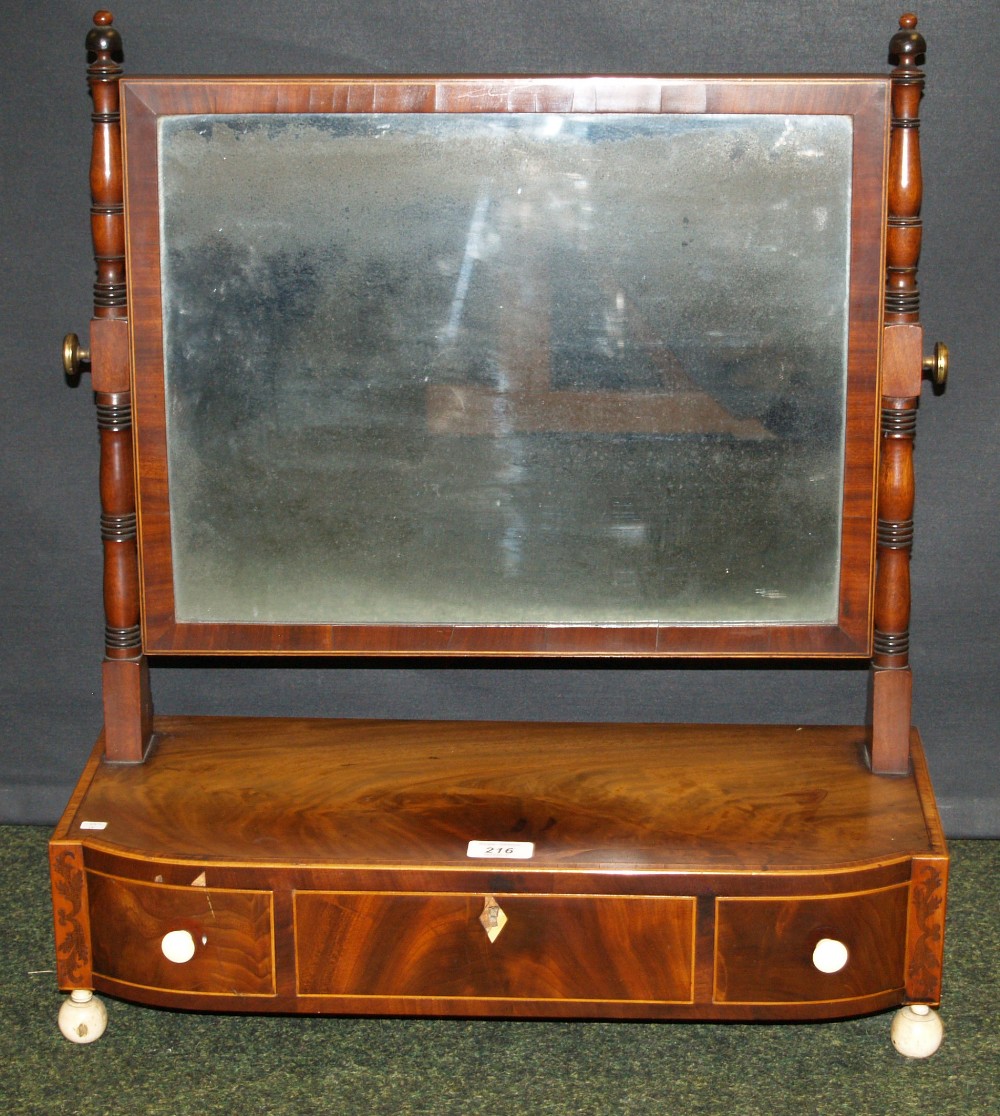 A Georgian inlaid mahogany toilet swing mirror, the glass raised above three drawers and having