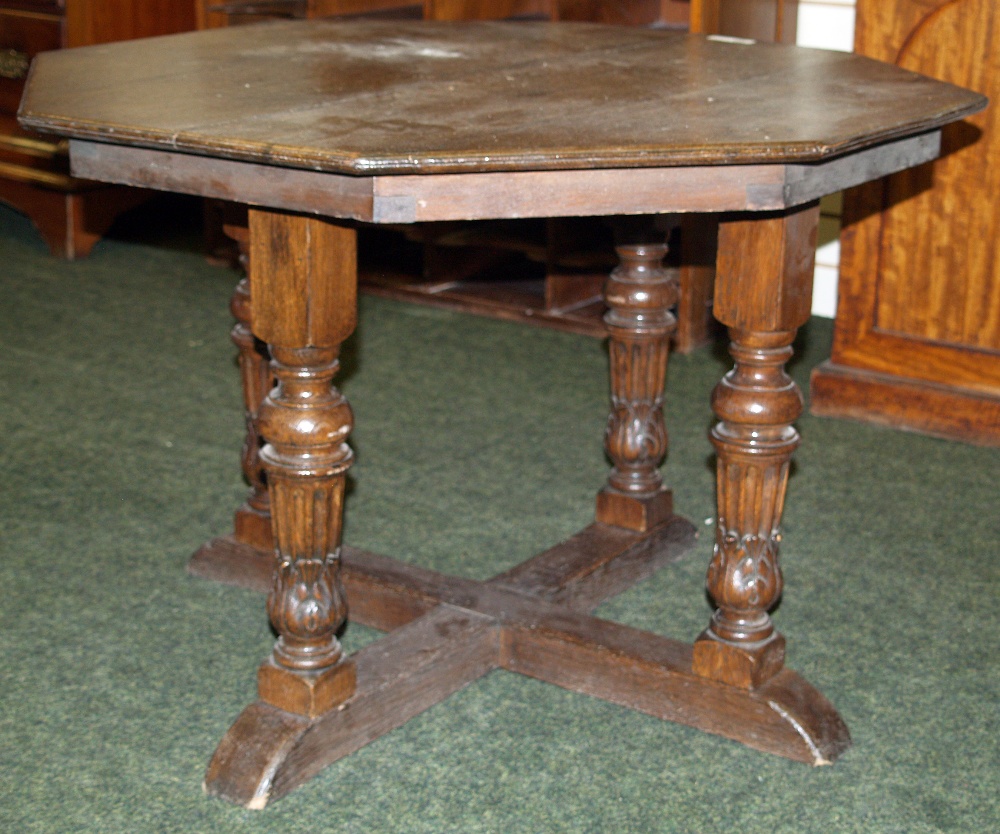 Oak octagonal table with carved supports, approximately 38 inches wide