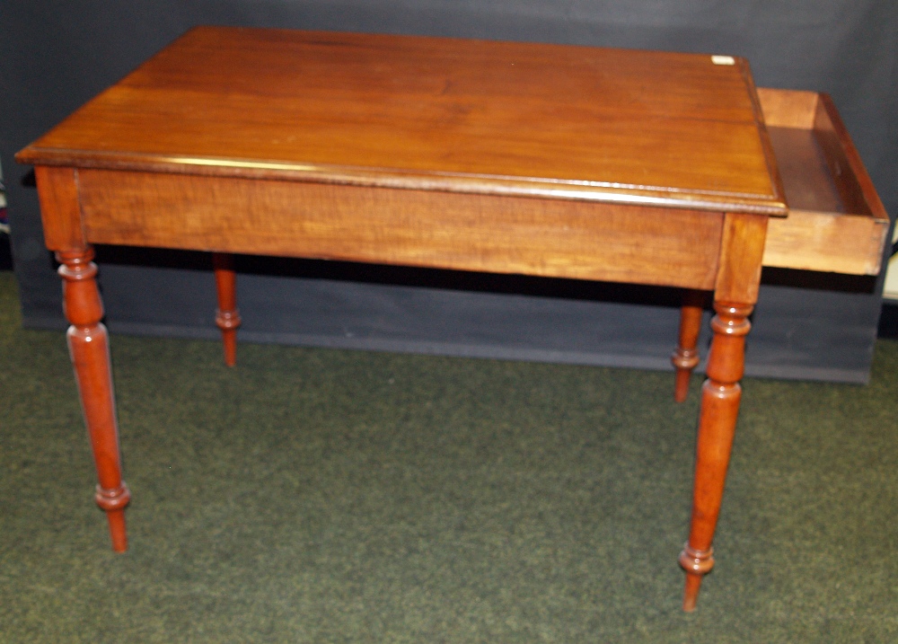 Mahogany library table with drawer at one end, raised on turned supports