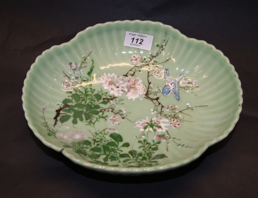 An 18th or 19th century Oriental celadon bowl, raised and painted detail to the lobed and shaped