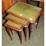 Nest of three glass-topped tables with leather inserts CONDITION REPORT; Fair condition, some