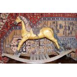 A children's vintage carved wooden rocking horse