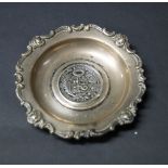 Hallmarked silver dish with ornate design with a coin (1894) to the centre