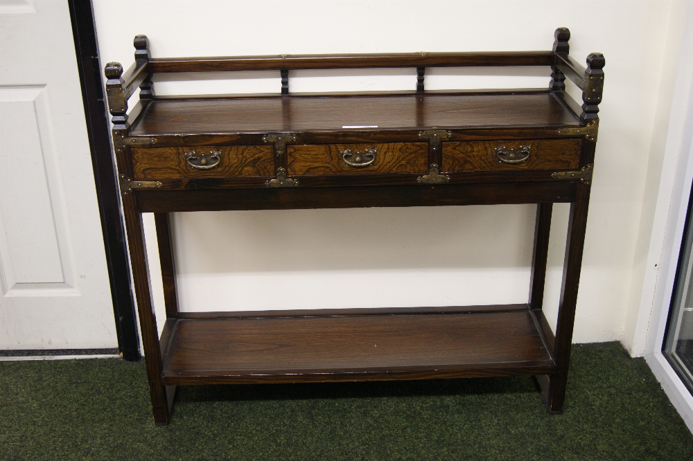 Dark wood console table with three short drawers