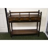 Dark wood console table with three short drawers