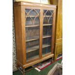 A tall oak 1920s two-door glazed bookcase (A/F)