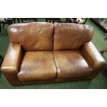 Leather two-seater sofa in tan