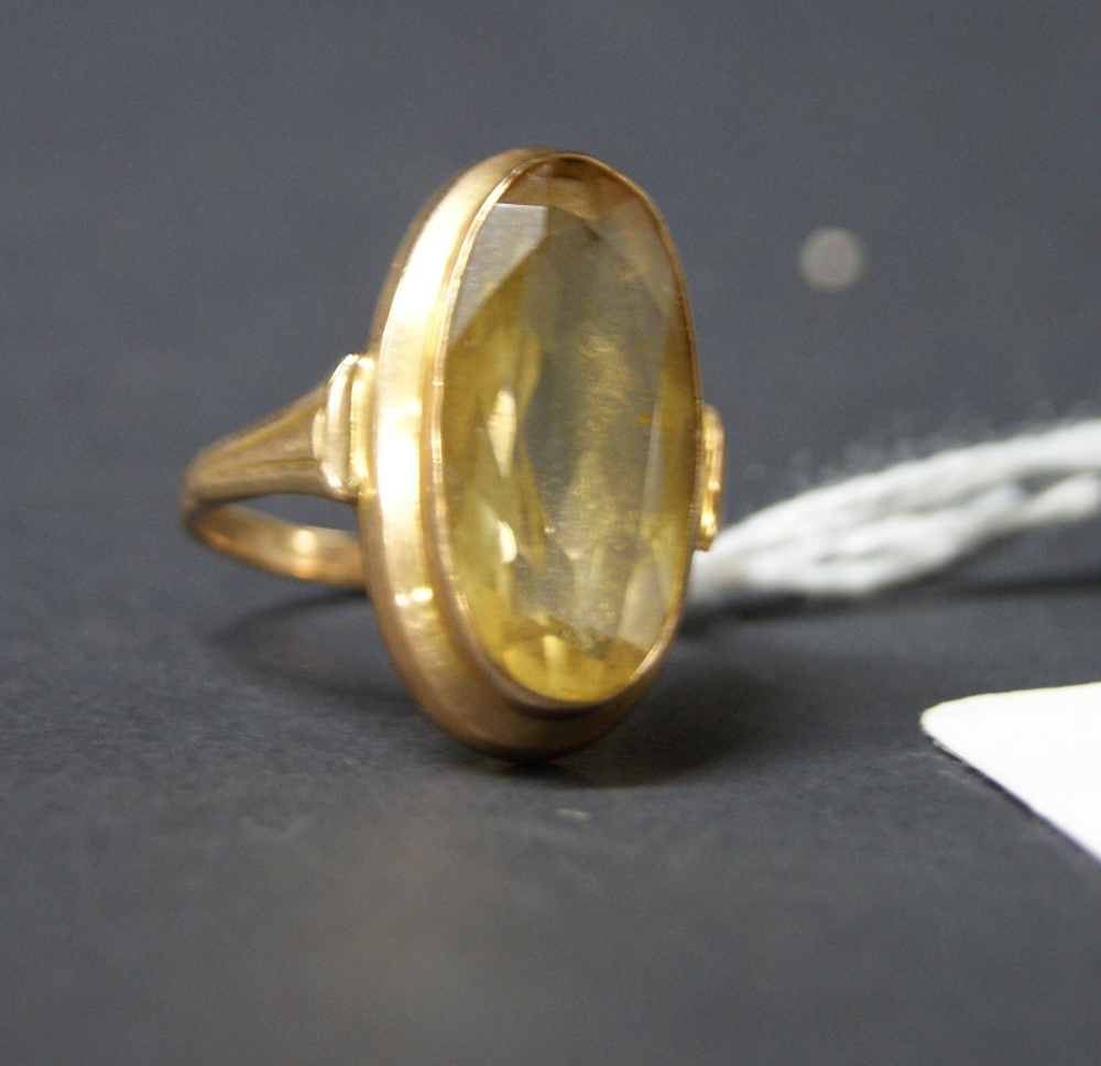 Gold ring with a central citrine stone