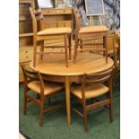 Teak dining suite comprising a round extending dining table,