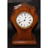 An hourglass-formed oak-cased mantel clock