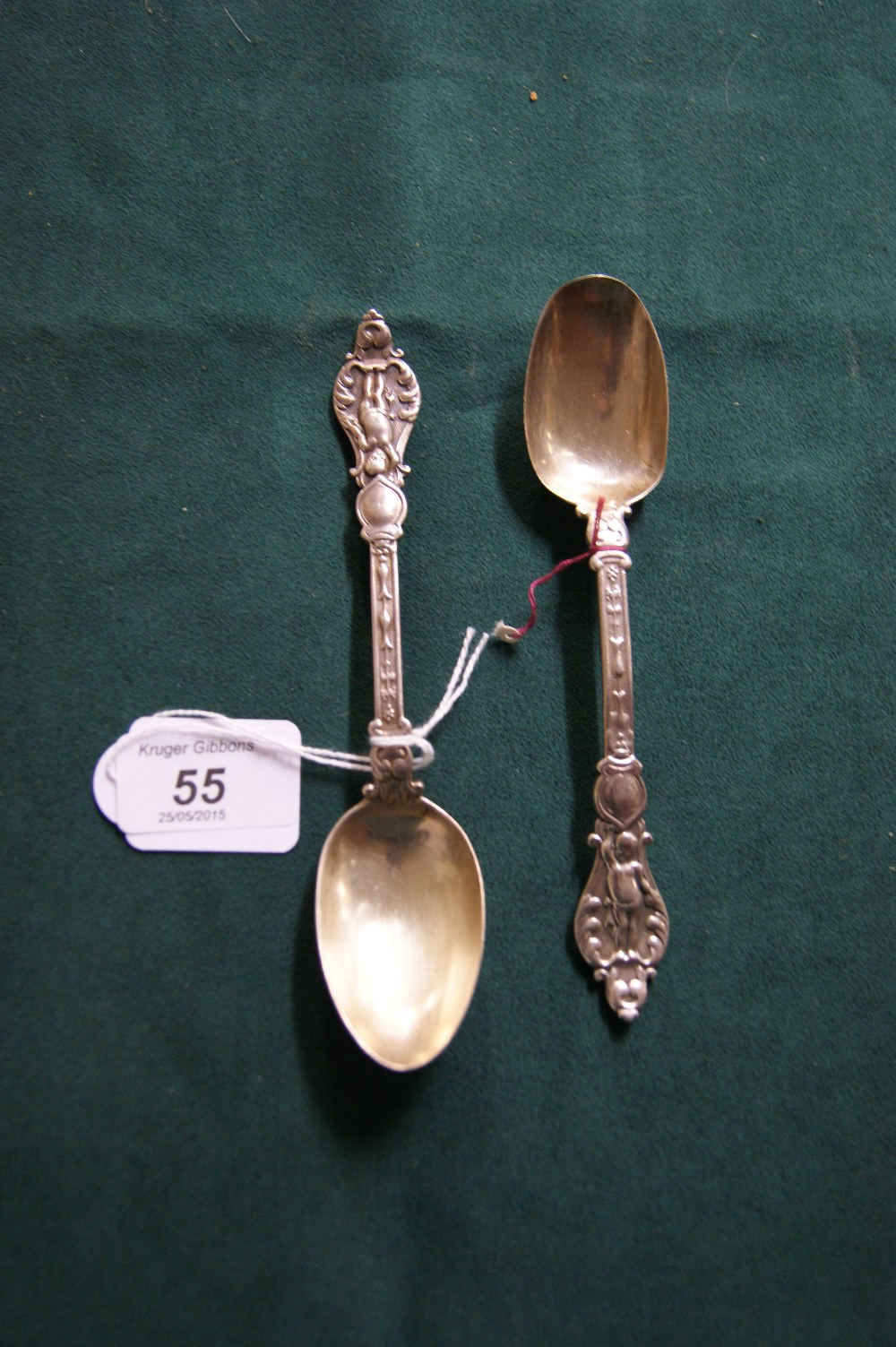 A near-pair of Victorian hallmarked silver spoons with relief-decorated grips (160mm & 165mm 76g)