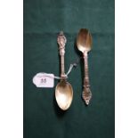 A near-pair of Victorian hallmarked silver spoons with relief-decorated grips (160mm & 165mm 76g)