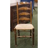 An oak farmhouse-style ladder-back chair