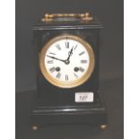 An ebonised French bracket clock having a circular enamelled dial with Roman chapters.