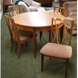 A G-Plan dining suite comprising an extending teak dining table and a set of four upholstered