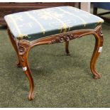 A carved walnut dressing stool with upholstered pad seat