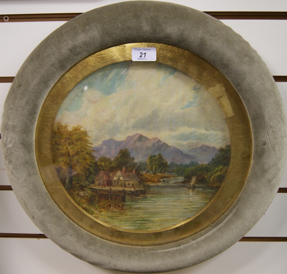 A 19th century circular oil on glass depicting a mountainous riverside scene.