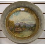 A 19th century circular oil on glass depicting a mountainous riverside scene.