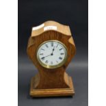 An hourglass-formed oak-cased mantel clock