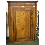 A George III oak and mahogany wall hanging cupboard.