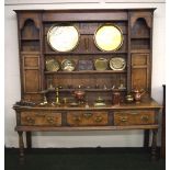 An 18th Century English oak dresser of three short drawers and a plate rack.