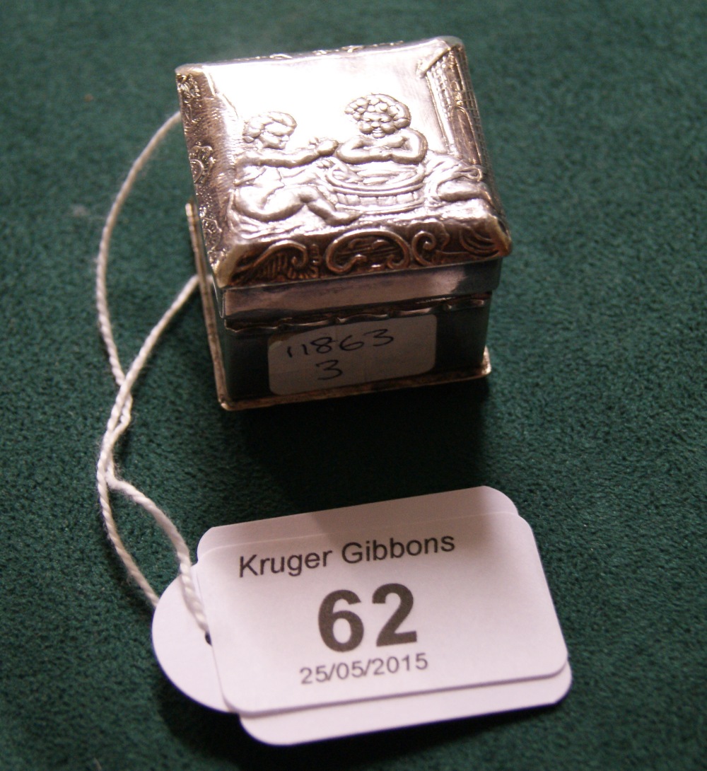 A hallmarked silver cube-form box, the hinged cover and the base with relief-decorated scenes.