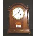 An Edwardian inlaid mahogany bracket clock, the circular enamelled dial with Arabic numerals,