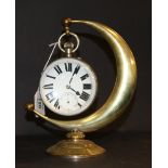 A 20th century desk clock of enlarged pocket watch form, with a crescent stand in brass.