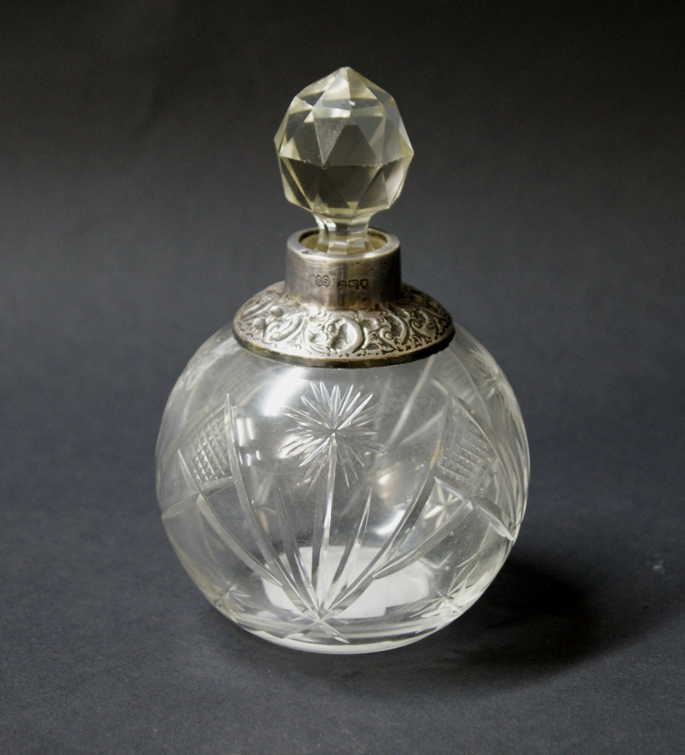 A hallmarked silver-topped perfume bottle,