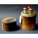 French leather-cased gentleman's trio of scent bottles with enamelled tops (A/F)