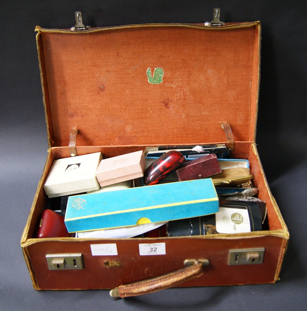 A suitcase of costume jewellery and jewellery boxes
