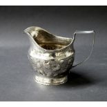 Georgian hallmarked silver jug with repoussé decoration.