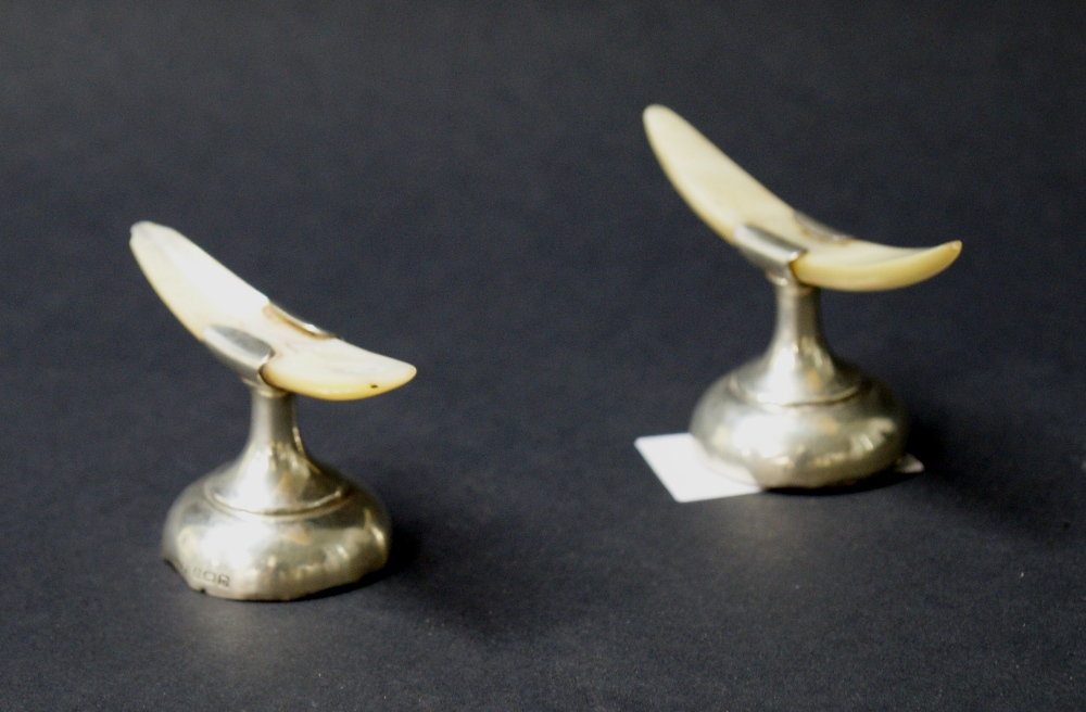 Two hallmarked silver and mother of pearl knife rests (A/F)